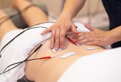 Electro stimulation in physical therapy to a young woman